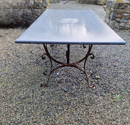 Large limestone top table  on antique wrought iron base