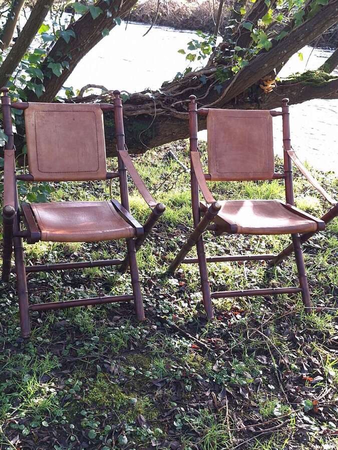 Pair of faux bamboo wood and leather campaign style folding chairs