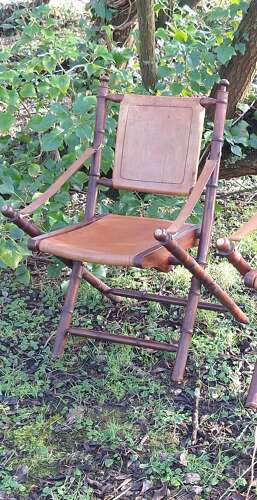 Pair of faux bamboo wood and leather campaign style folding chairs