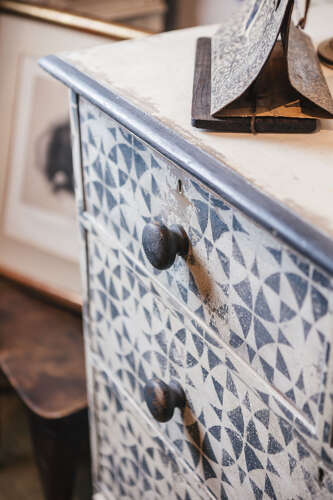 Antique pine chest of drawers with later painted geometric pattern
