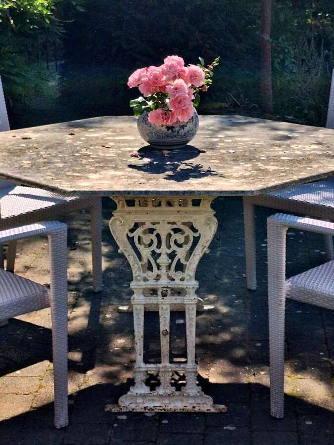 Octagonal composite stone top table with cast iron base